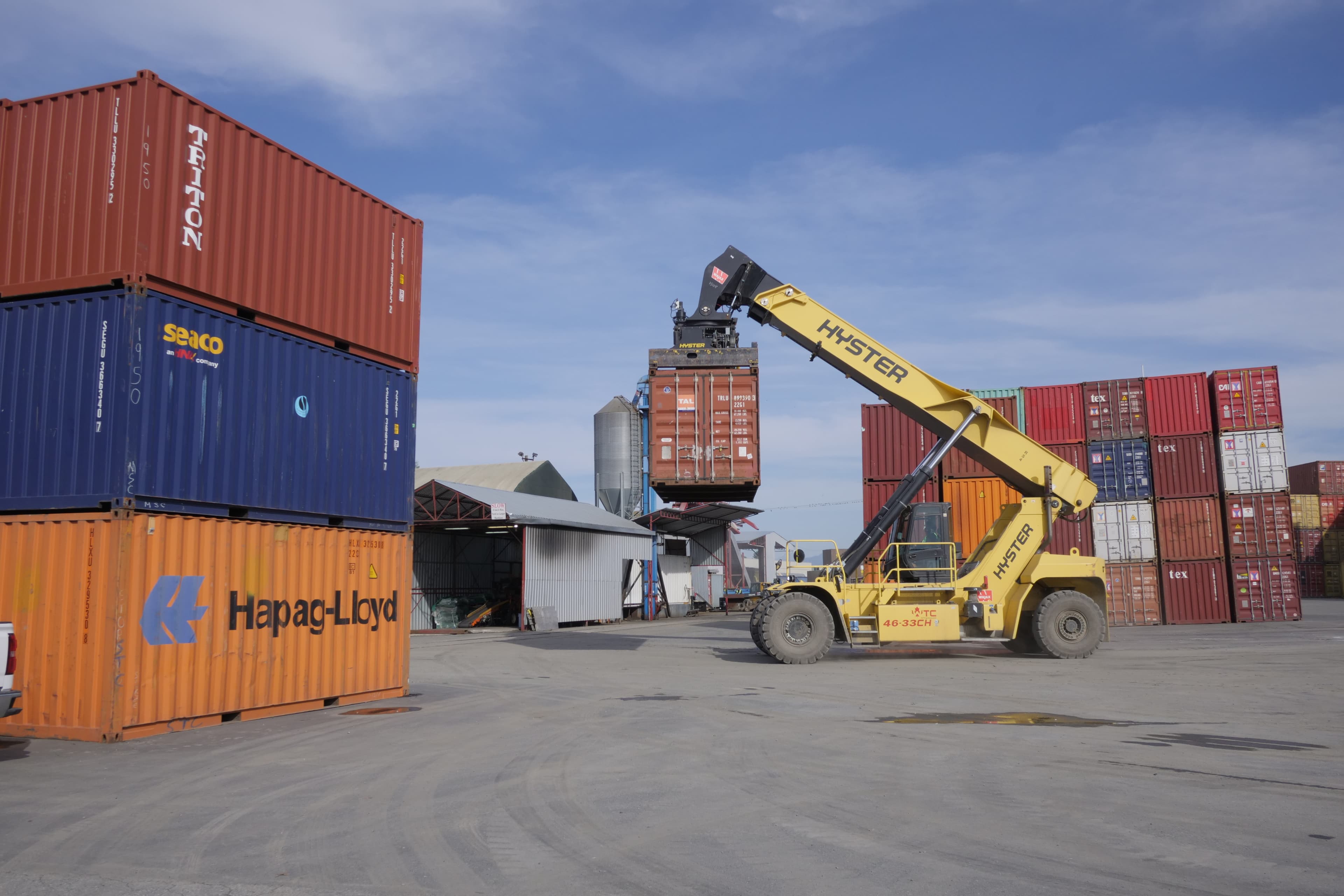 Crane truck lifting cargo container